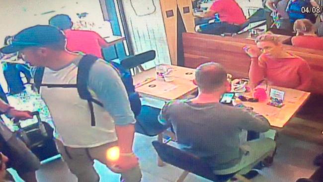 Brett Costello can be seen arriving at the cafe with his bag pictured in the bottom left of the screen.