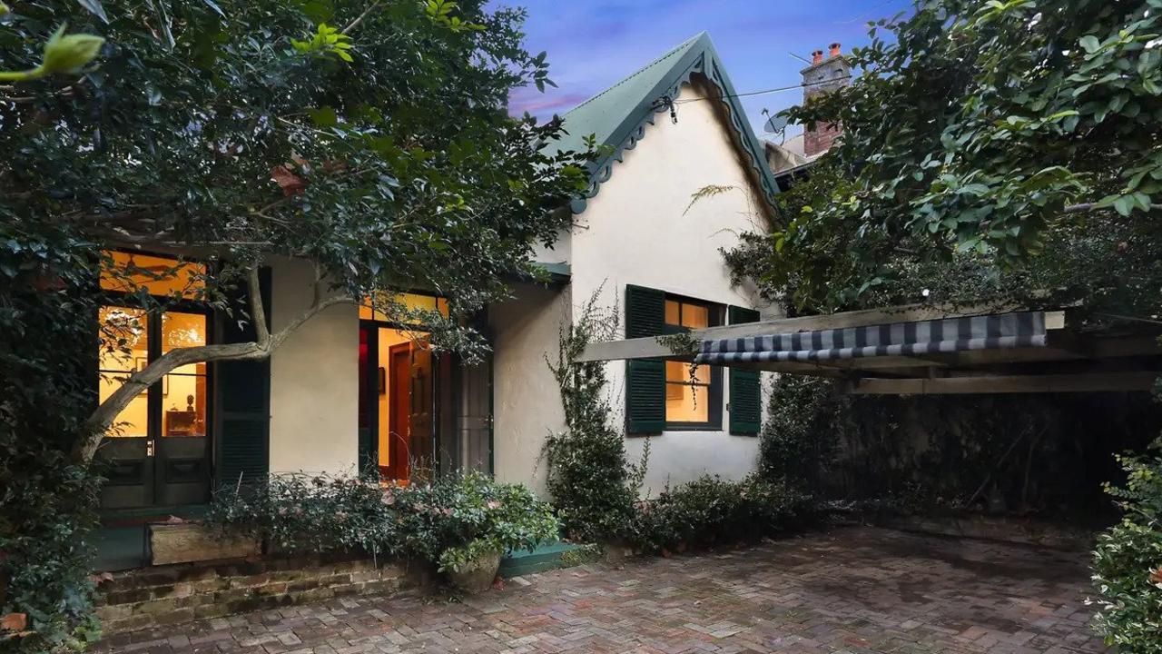 The large freestanding home sits behind a high fence in Bourke St.