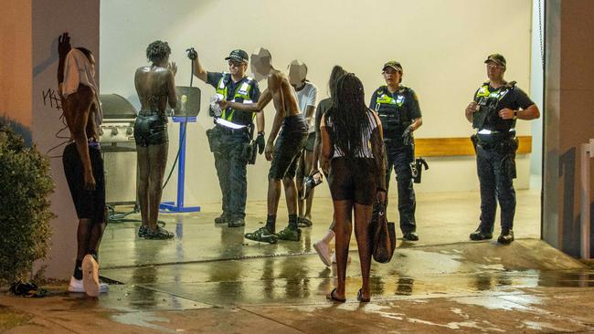 Youths douse themselves in water after being sprayed.