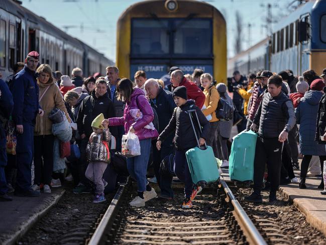 People queue to board a train back to Ukraine across the border from Hungary. More than two million refugees have fled Ukraine since the start of Russia's military offensive, according to the UN. Picture: Christopher Furlong/Getty Images