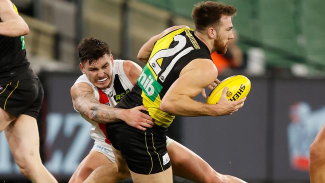 MELBOURNE, AUSTRALIA - JUNE 25: Noah Balta of the Tigers injures his leg as Josh Battle of the Saints tackles him during the 2021 AFL Round 15 match between the Richmond Tigers and the St Kilda Saints at the Melbourne Cricket Ground on June 25, 2021 in Melbourne, Australia. (Photo by Michael Willson/AFL Photos via Getty Images)