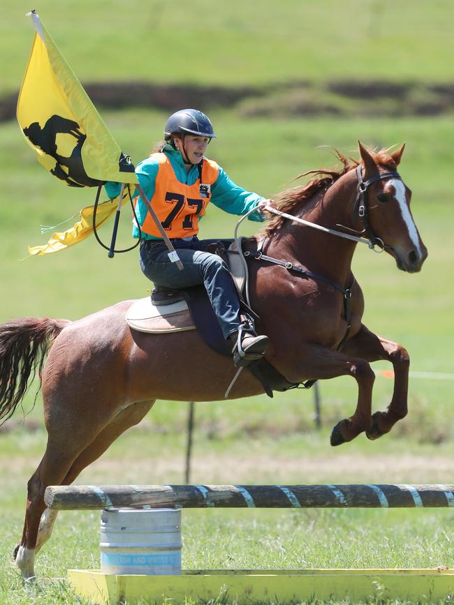 Ruby McCourt and her horse clear a jump.