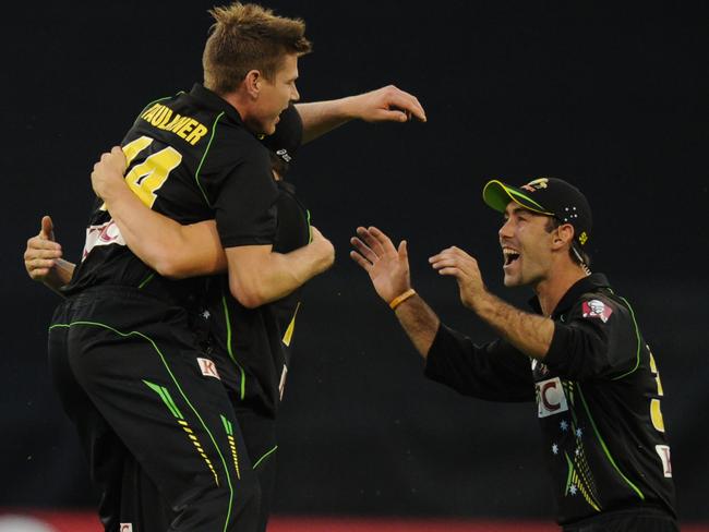 James Faulkner celebrates one of his three wickets with Glenn Maxwell. AFP PHOTO/ MAL FAIRCLOUGH.