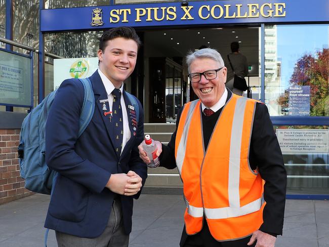 College Principal Mr John Couani greets students with hand santiser and the 'new rules' upon return to school Monday 11th May. St Pius X College Chatswood students return. Monday saw St Pius X College Chatswood students return to school after five weeks of online learning during the Covid 19 shutdown. Picture: Tracy Bradley