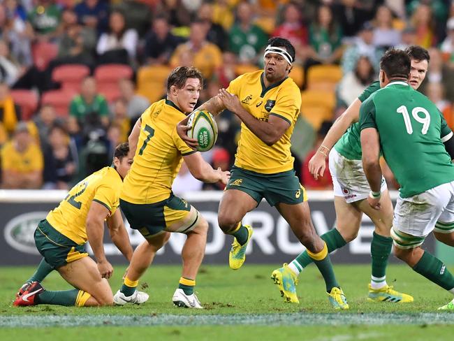 Kurtley Beale (centre) of the Wallabies in action during the First Test between Australia and Ireland at Suncorp Stadium in Brisbane, Saturday, June 9, 2018. (AAP Image/Darren England) NO ARCHIVING, EDITORIAL USE ONLY