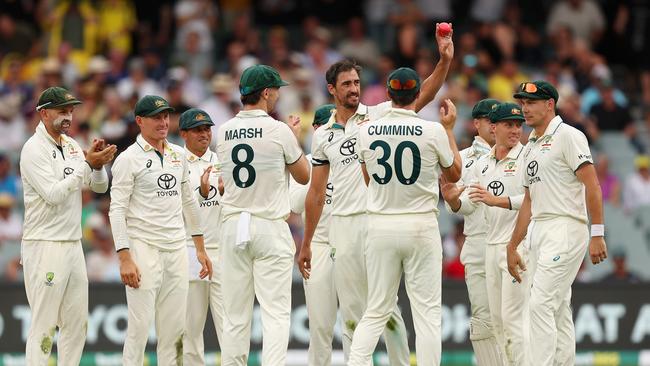 Mitchell Starc celebrates with teammates after claiming his fifth Indian wicket on Friday. Photo: Getty