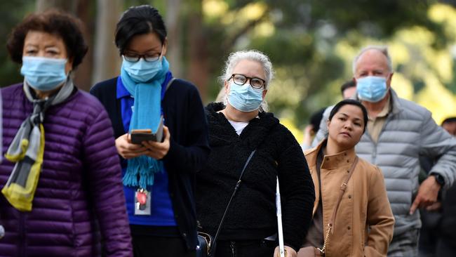 Members of the public queue outside at a mass COVID-19 vaccination hub in Sydney. Picture: NCA NewsWire/Joel Carrett