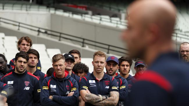 Melbourne players look on as Nathan Jones speaks to the media ahead of his 300th game.