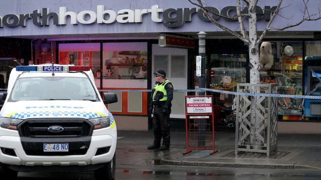 Tasmania Police attend the scene. Picture: LUKE BOWDEN