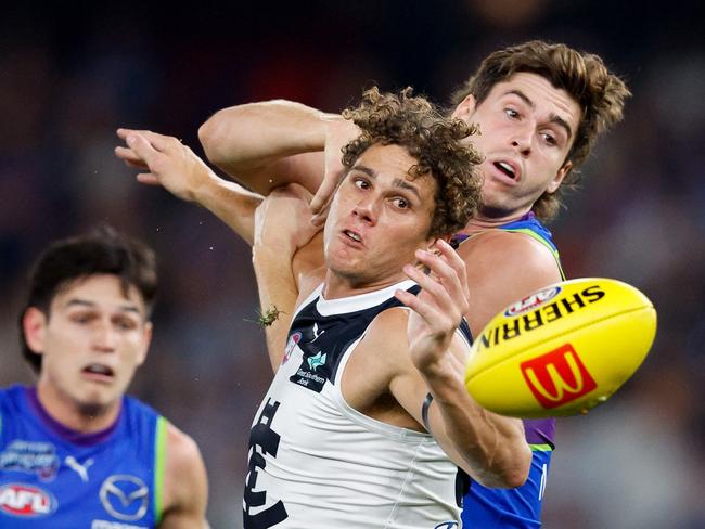 MELBOURNE, AUSTRALIA - MARCH 29: Charlie Curnow of the Blues and Kallan Dawson of the Kangaroos compete for the ball during the 2024 AFL Round 03 match between the North Melbourne Kangaroos and the Carlton Blues at Marvel Stadium on March 29, 2024 in Melbourne, Australia. (Photo by Dylan Burns/AFL Photos via Getty Images)