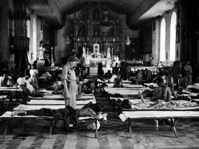 Army nurses work in a church converted to a hospital for the wounded on Leyte Island.