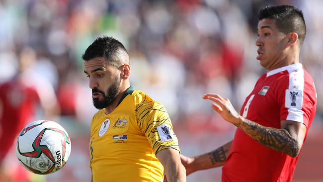 Socceroos defender Aziz Behich battles for possession with Jonathan Zorrilla of Palestine. Picture: Getty Images