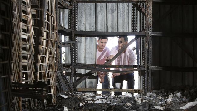 Will Young and Tom Latchford co-owners of SA Marquee, Wedding and Events at the remains of the shed where all of their equipment was stored. Picture: Brett Hartwig