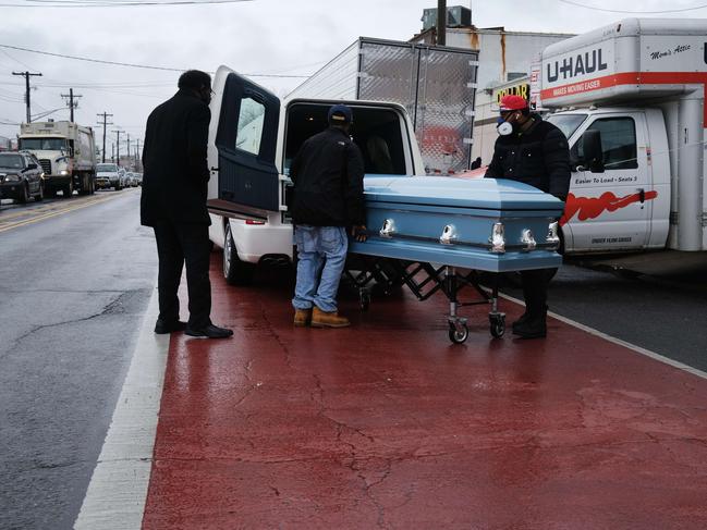 A casket is taken to a hearse from a Brooklyn funeral home. Dozens of bodies have been discovered in unrefrigerated overflow trucks outside the business following a complaint of a foul odour. Picture: Getty Images/AFP