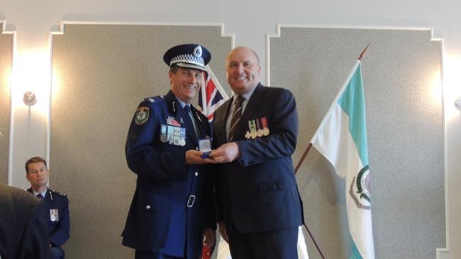 Inspector Stephen Fowler (left) receives his NSW Police Medal 35 year clasp from Baulkham Hills state Liberal MP and Minister David Elliott