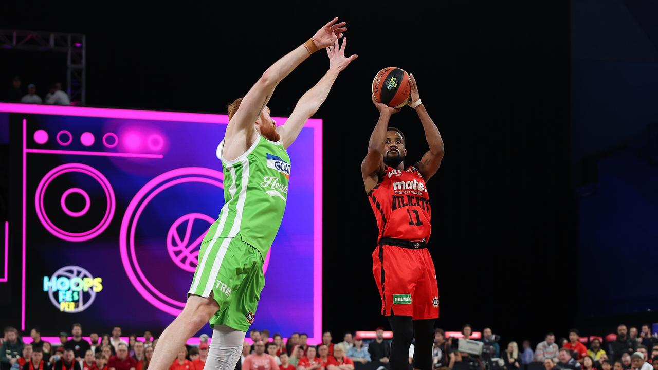 PERTH, AUSTRALIA - SEPTEMBER 20: Bryce Cotton of the Wildcats puts a shot up against Angus Glover.