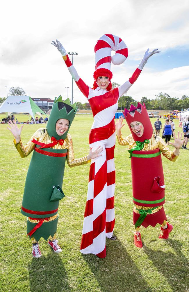 Heidi, Sarah and Tanya from 'Izit? Entertainment' pose for a photograph at Caboolture Christmas Carols. (AAP Image/Richard Walker)