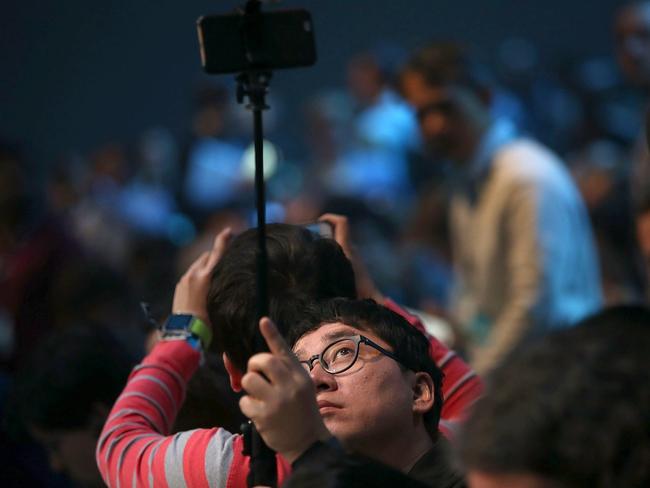 It’s so tech-citing ... an attendee uses a selfie stick to take photographs before the start of the opening address. Picture: Justin Sullivan/Getty Images/AFP