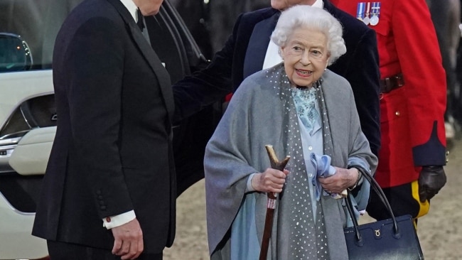 The 96-year-old monarch walking to her seat with the use of a cane. Picture: Getty Images