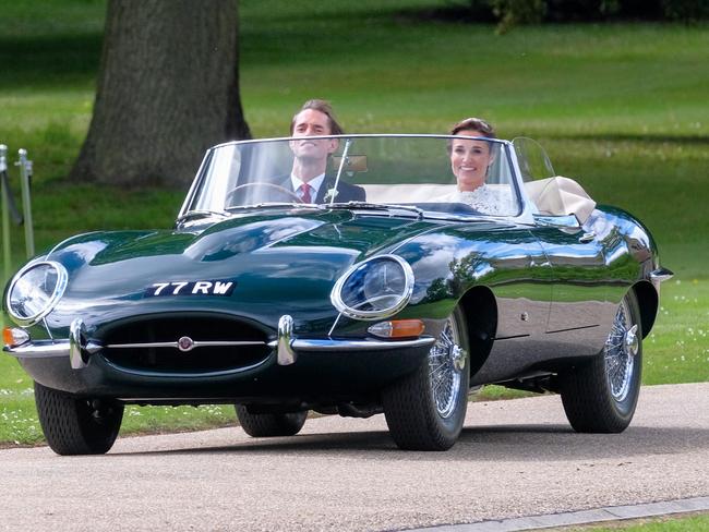 Just married ... Mr and Mrs Matthews leave Englefield house in the vintage Jag.