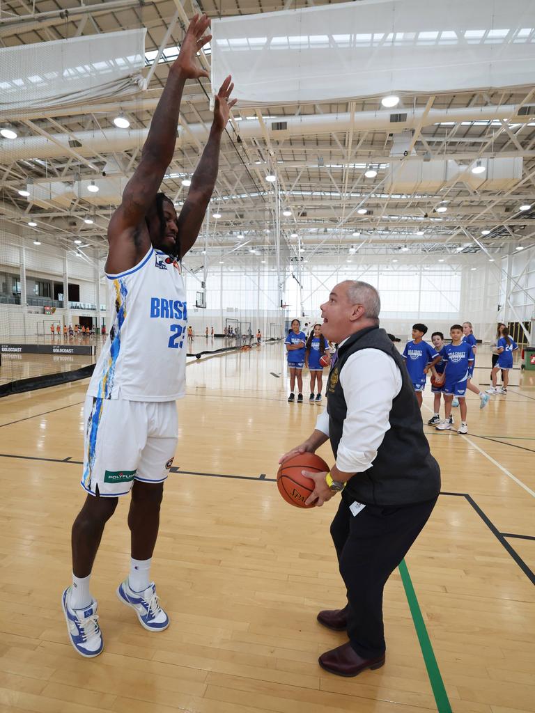 Mayor Tom Tate goes over the top during a little one on one with Brisbane Bullets star Casey Prather. Picture Glenn Hampson