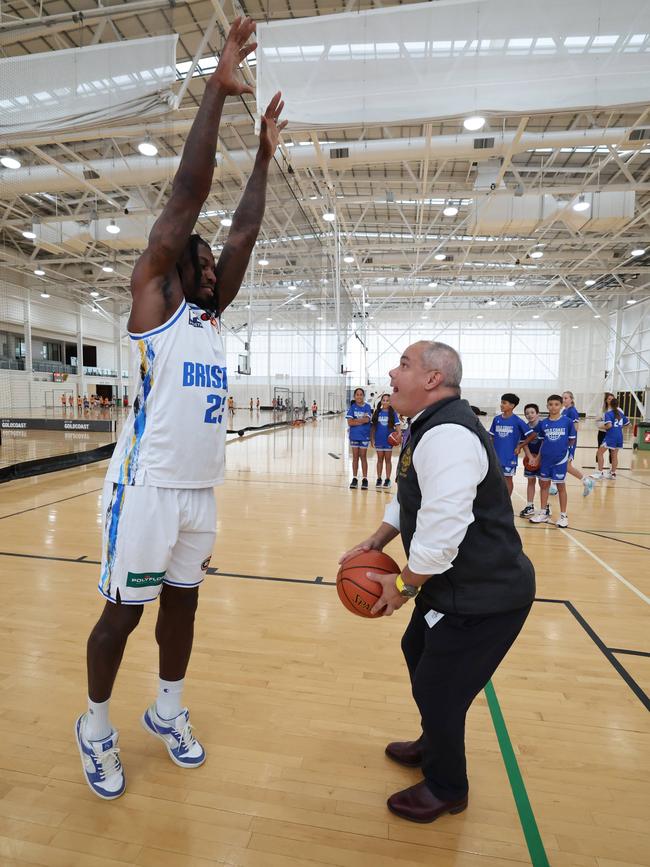 Mayor Tom Tate goes over the top during a little one on one with Brisbane Bullets star Casey Prather. Picture Glenn Hampson