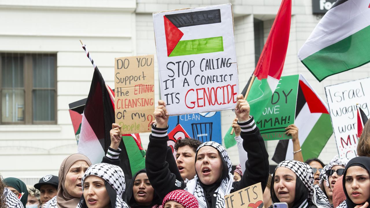 Students carried cardboard signs with one saying: ‘Stop calling it a conflict, its genocide”. Picture: NCA NewsWire / Monique Harmer