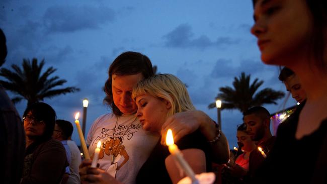 Mourners hold a candlelight vigil for the victims of a mass shooting at the Pulse nightclub in downtown Orlando. Picture: AP/David Goldman