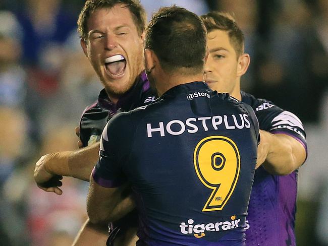 Tim Glasby celebrates his try for the Storm against the Sharks.