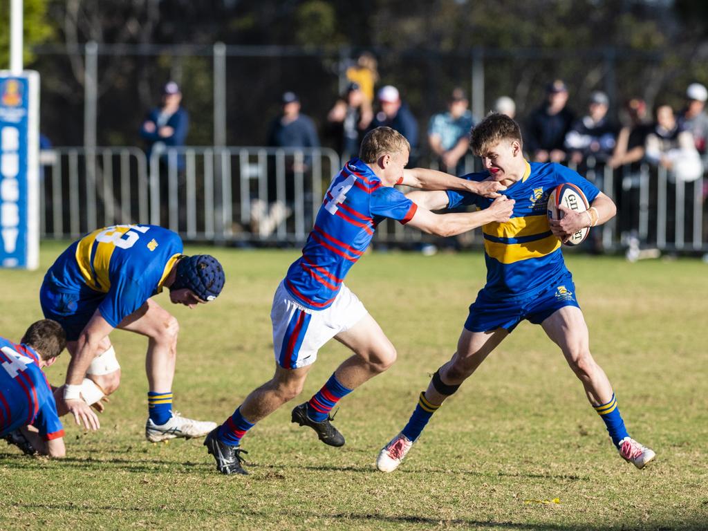 Tom McDonald (left) of Downlands tackles Will Holley of Grammar in O'Callaghan Cup on Grammar Downlands Day at Downlands College, Saturday, August 6, 2022. Picture: Kevin Farmer