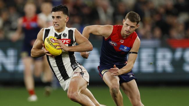 Nick Daicos of the Magpies leaves Judd McVee of the Demons in his wake. Picture: Michael Klein.