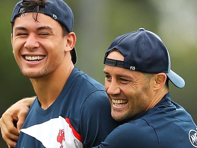 SYDNEY, NEW SOUTH WALES - MARCH 05:  Joseph Manu and Cooper Cronk share a laugh during a Sydney Roosters NRL training session at Kippax Lake on March 5, 2018 in Sydney, Australia.  (Photo by Mark Kolbe/Getty Images)