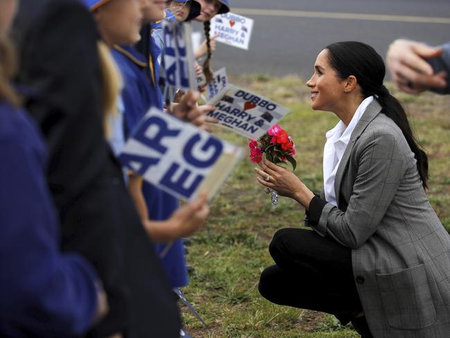 Meghan gets up close and personal with some school kids in Dubbo. Picture: Phil Noble/AP