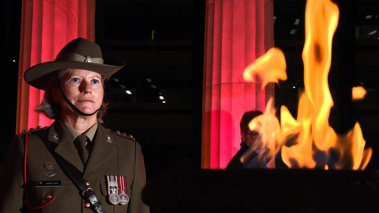 Captain Adelle Catts of the Army reserve plays her respects at the Dawn Service.  Brisbane Anzac Day Dawn Service at the Shrine of Remembrance, Anzac Square.Thursday April 25, 2019. (AAP image, John Gass)