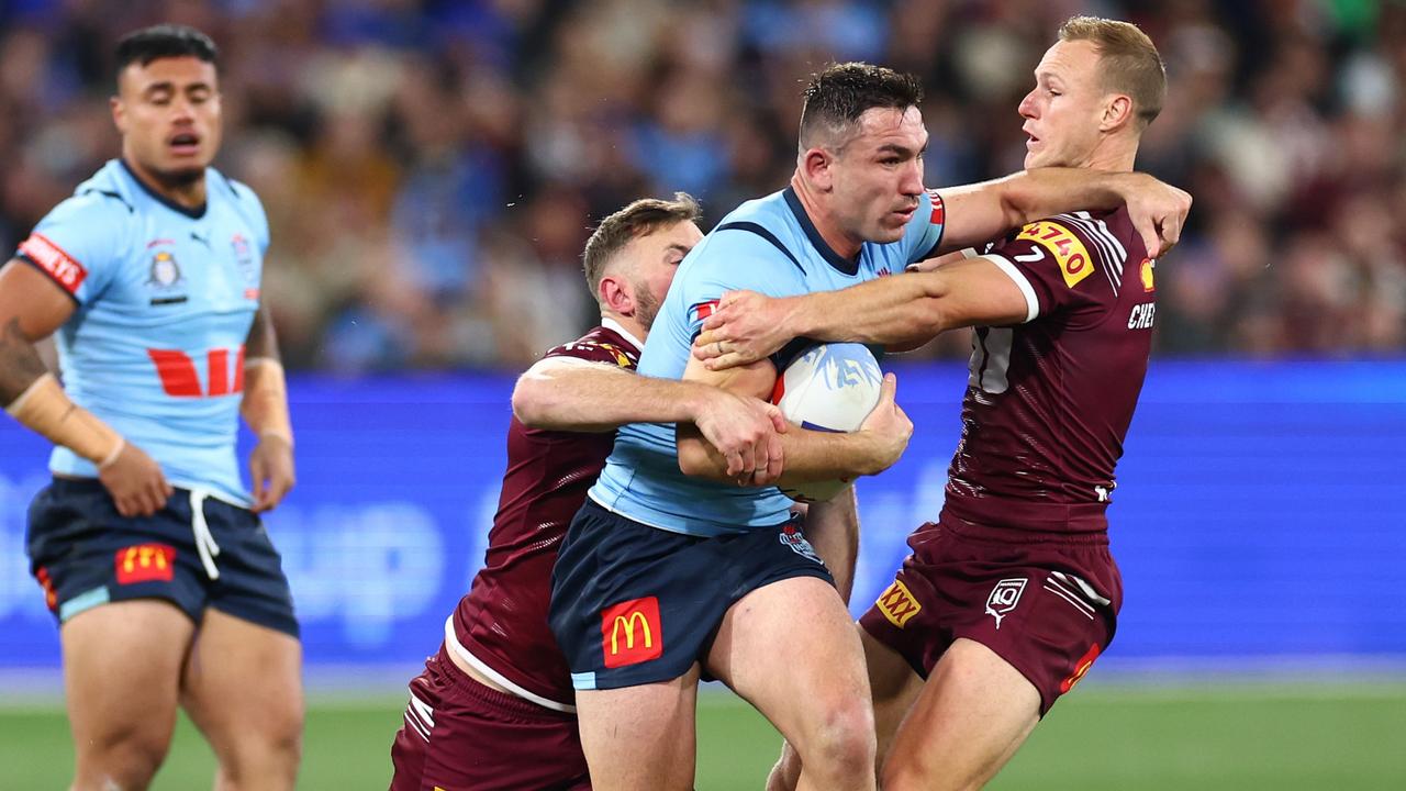 Reece Robson of the Blues is tackled by Daly Cherry-Evans of the Maroons during game two of the men's State of Origin series between New South Wales Blues and Queensland Maroons at the Melbourne Cricket Ground on June 26, 2024 in Melbourne, Australia. (Photo by Quinn Rooney/Getty Images)