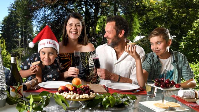 Louise Pfeiffer with partner Phil Crawford and their children Orlando, 8 and Sebastian 11, dining outside in their garden. Picture: Tricia Watkinson