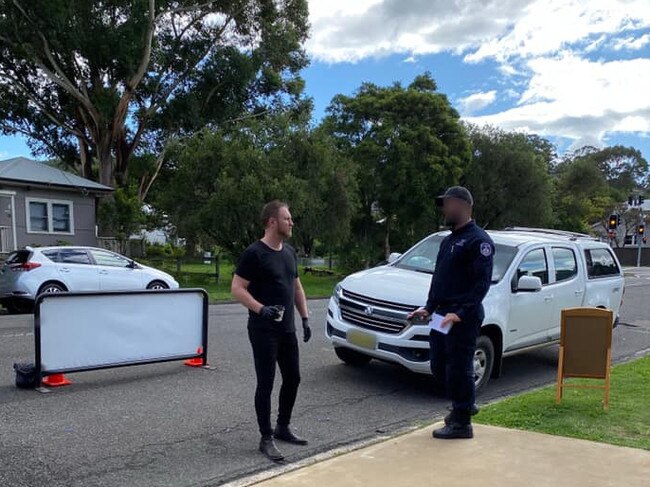 Fahrenheit Cafe owner Logan Dart talking to a council ranger who threatened him with $900 fines for his drive-through coffee bay at East Gosford. Picture: supplied