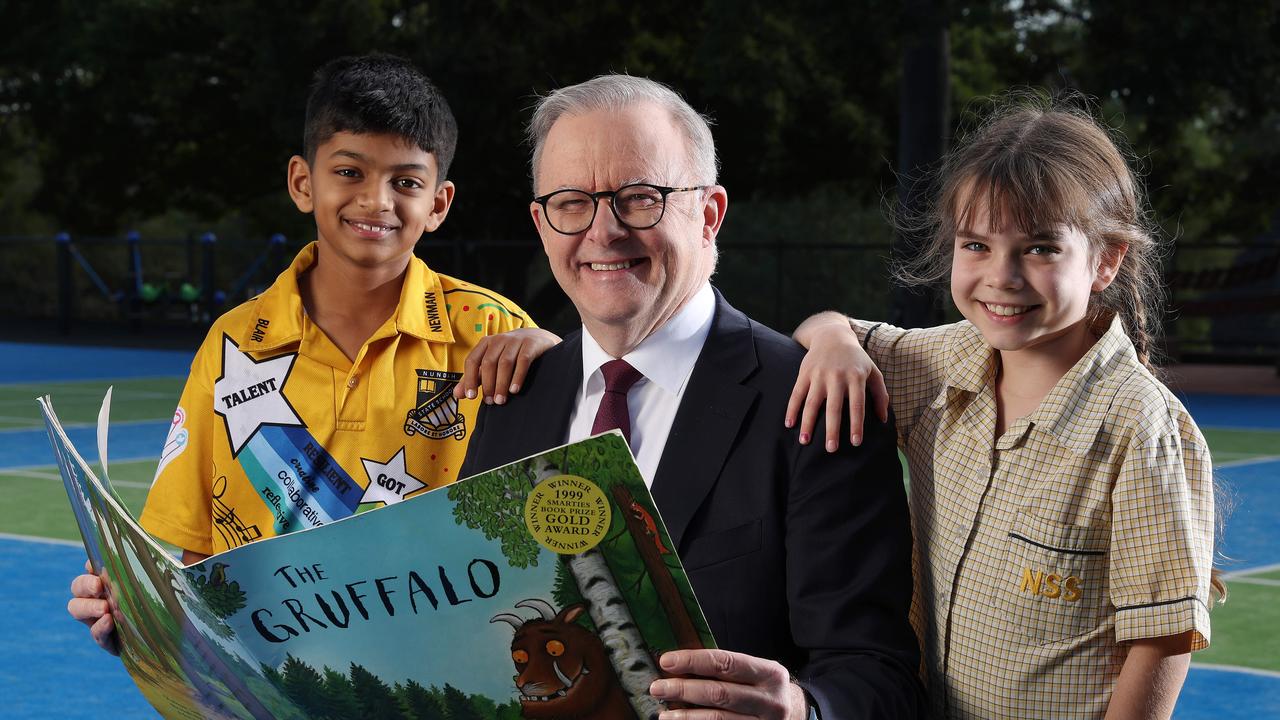 Prime Minister Anthony Albanese reading with Nundah State School students Avhi Hejeebu, 11, year 6; and Matilda Sedgman, 8, year 3; Prime Minister's Spelling Bee launch. Picture: Liam Kidston