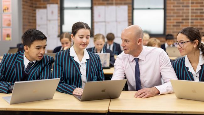 Newcastle Grammar School Head of Global Studies Daniel Locking with 2023 graduates Isaac Phath-Le, Olivia Johnson and Hannah Choi. Picture: Supplied