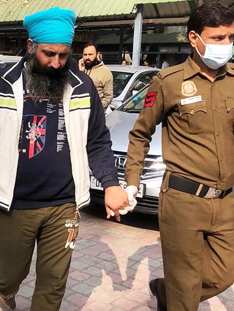 Rajwinder Singh being led into a New Delhi Court. Picture: Tawqeer Hussain