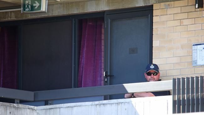 Police outside a unit which has become a crime scene. Photo: David Clark.