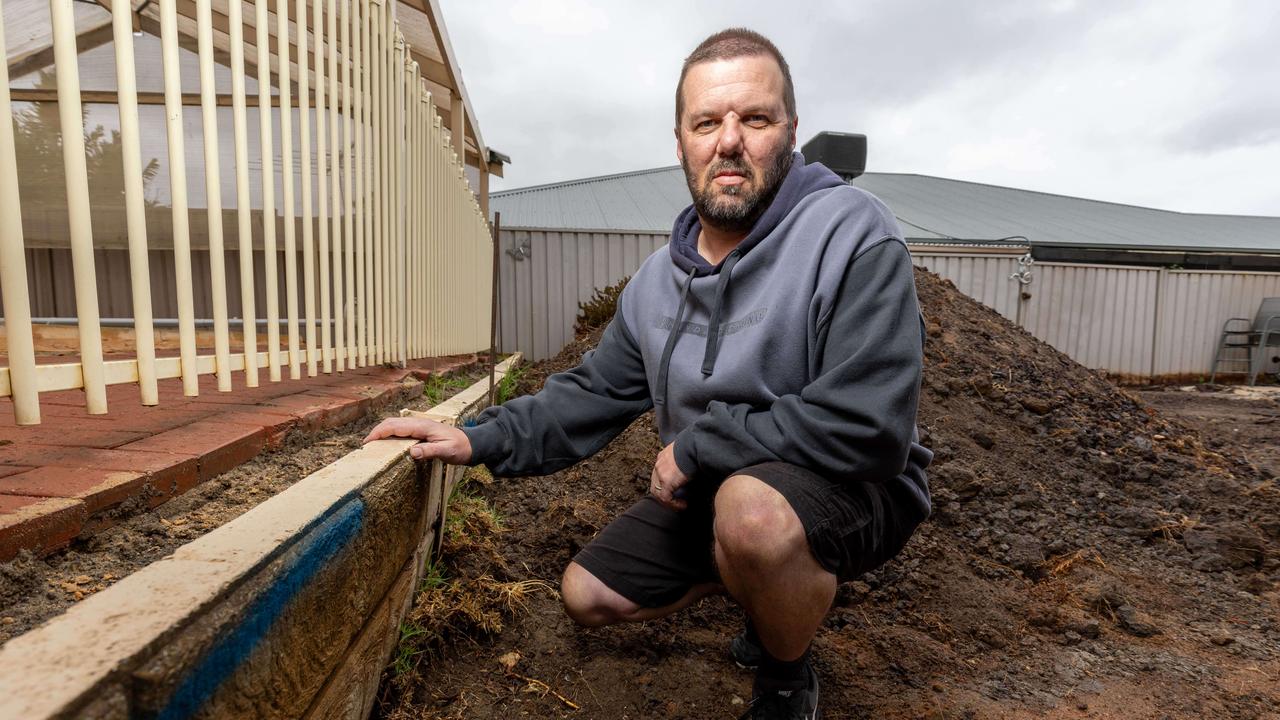 Keith at his home in Woodcroft after paying Adelaide Exposed Concrete to repair a retaining wall and relandscape his lawn. Picture: Ben Clark