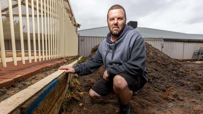 Keith at his home in Woodcroft after paying Adelaide Exposed Concrete to repair a retaining wall and relandscape his lawn. Picture: Ben Clark
