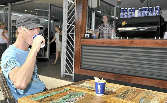 STREET SCENE: Adam Fletcher, barista at the 114 cafe on Keen St in Lismore. In the back Peter Fleming, owner of the cafe. Picture: Mireille Merlet-Shaw