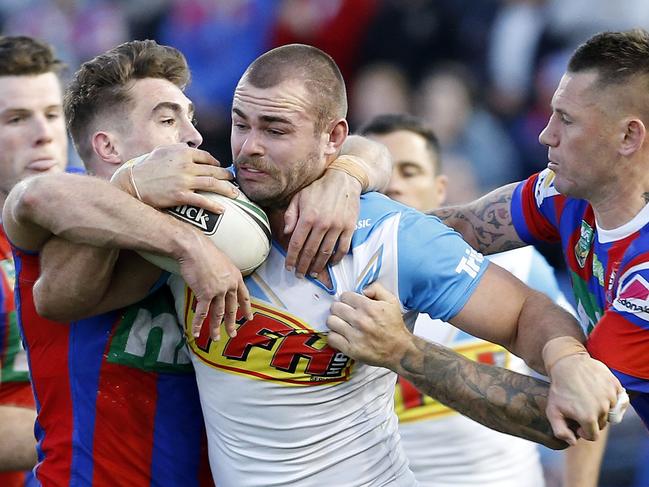 Keegan Hipgrave of the Titans is tackled during the Round 19 NRL match between the Newcastle Knights and the Gold Coast Titans at McDonald Jones Stadium in Newcastle, Saturday, July 21, 2018. (AAP Image/Darren Pateman) NO ARCHIVING, EDITORIAL USE ONLY