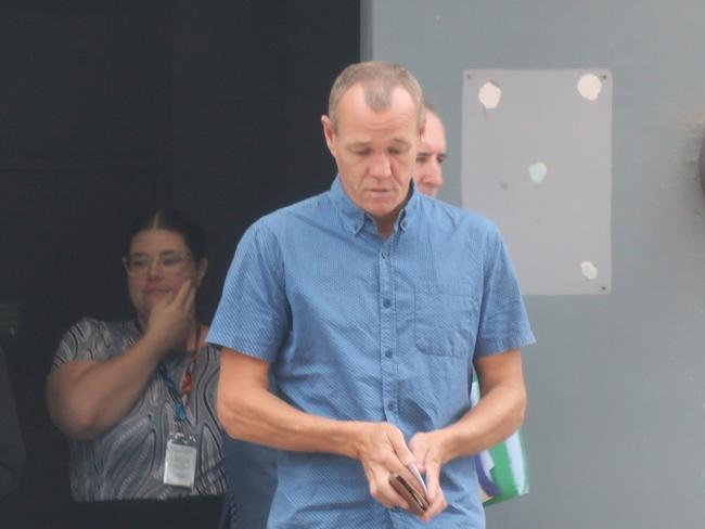 Mr Commane (centre, blue shirt) leaving Wyong Local Court after his previous appearance. Picture: NewsLocal