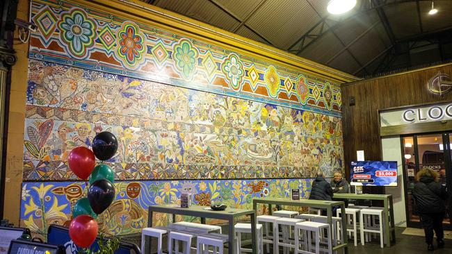 A mural partially covered by the Clocks venue at Flinders Street Station. Picture: Mark Stewart