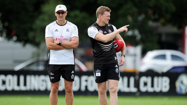 David Buttifant watches over Collingwood coach Nathan Buckley.