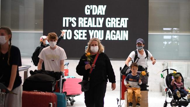 Families walk out of the arrivals hall at Sydney's International Airport on November 1, 2021, as Australia's international border reopened almost 600 days after a pandemic closure began. Photo: Saeed Khan / AFP