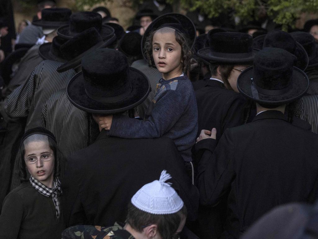 Ultra-Orthodox Jewish men and children collect water from a mountain spring near Jerusalem during the Maim Shelanu ceremony, ahead of Pesach. Picture: Menahem Kahana/AFP